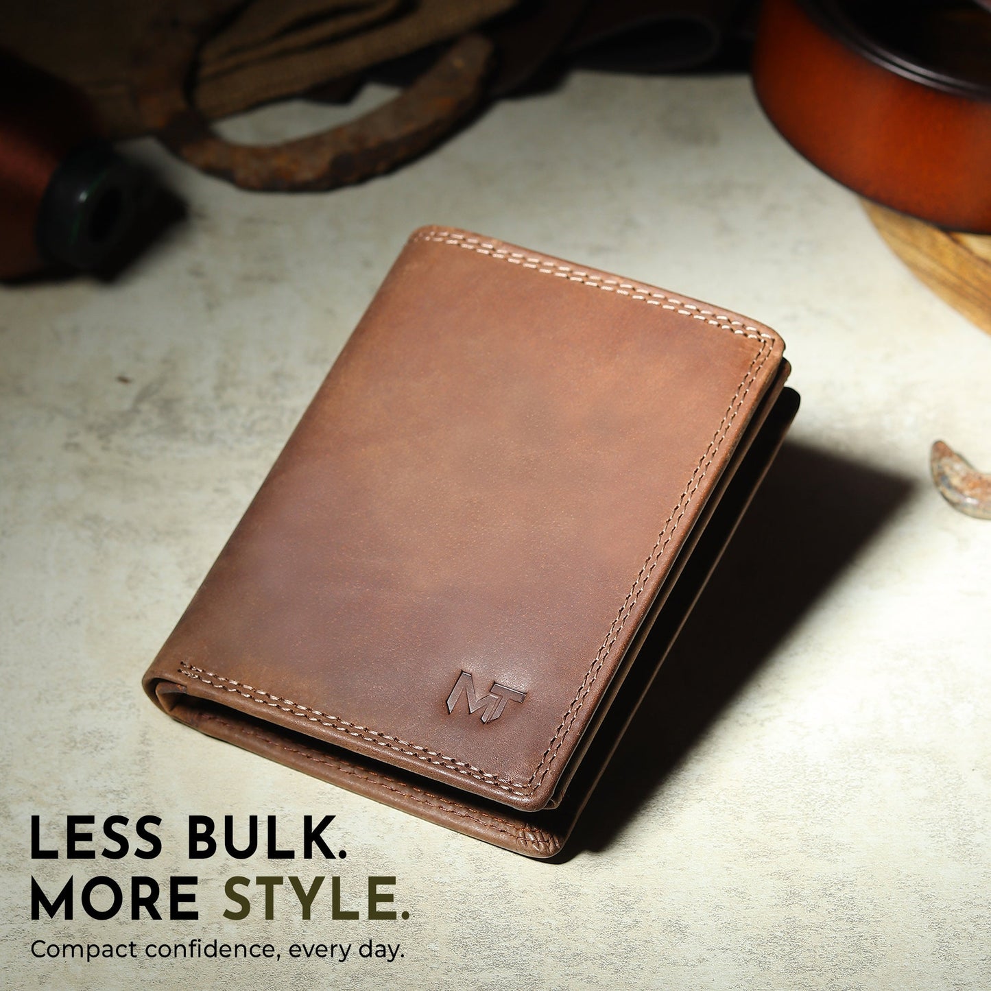 Men's vertical leather wallet in brown with stitched edge and MT logo on front.