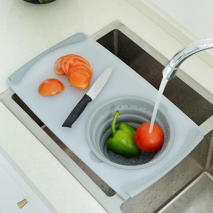 Light blue plastic chopping board with sink-style draining bowl and knife