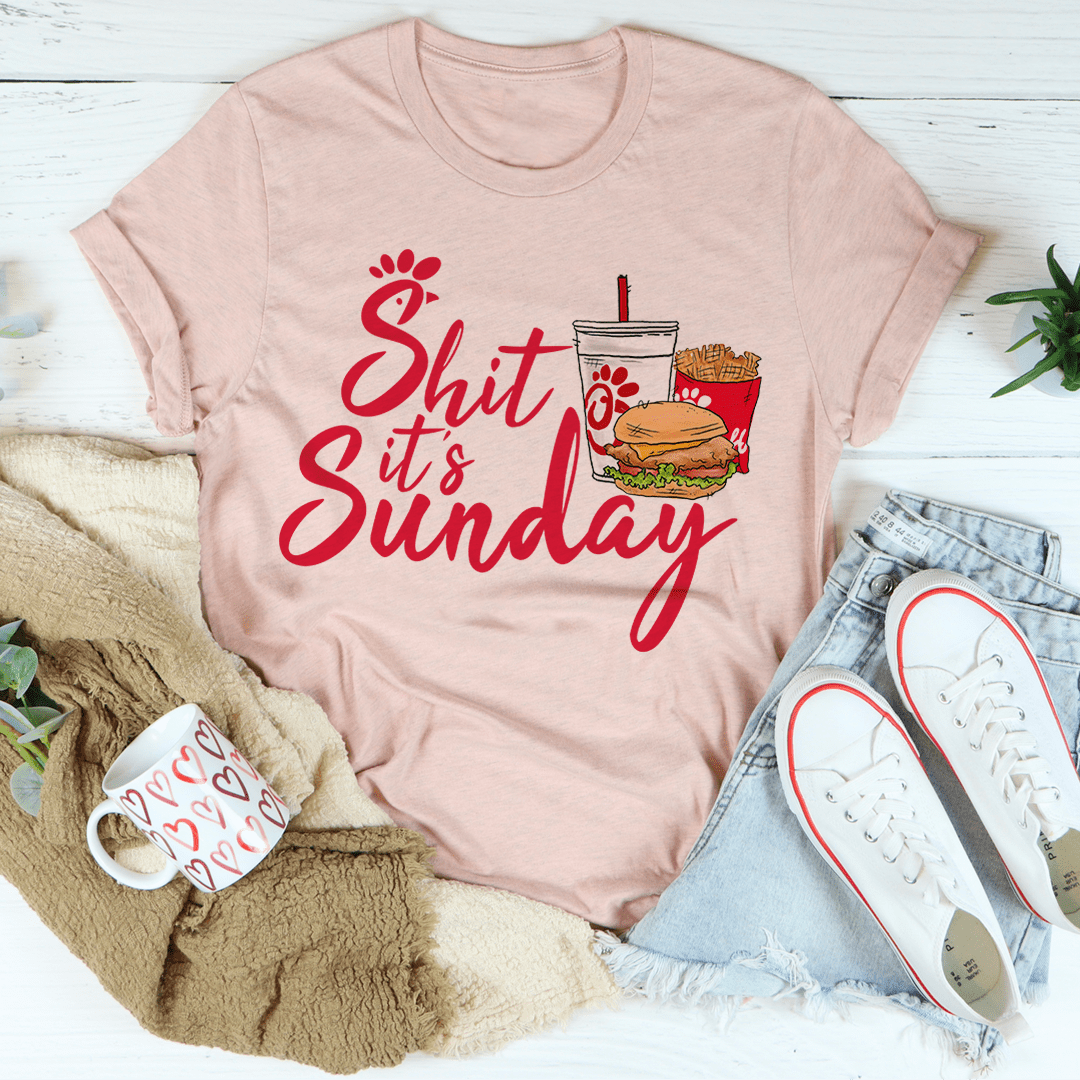 Pink crewneck T-shirt with red "Shit It's Sunday" text and paw print graphic