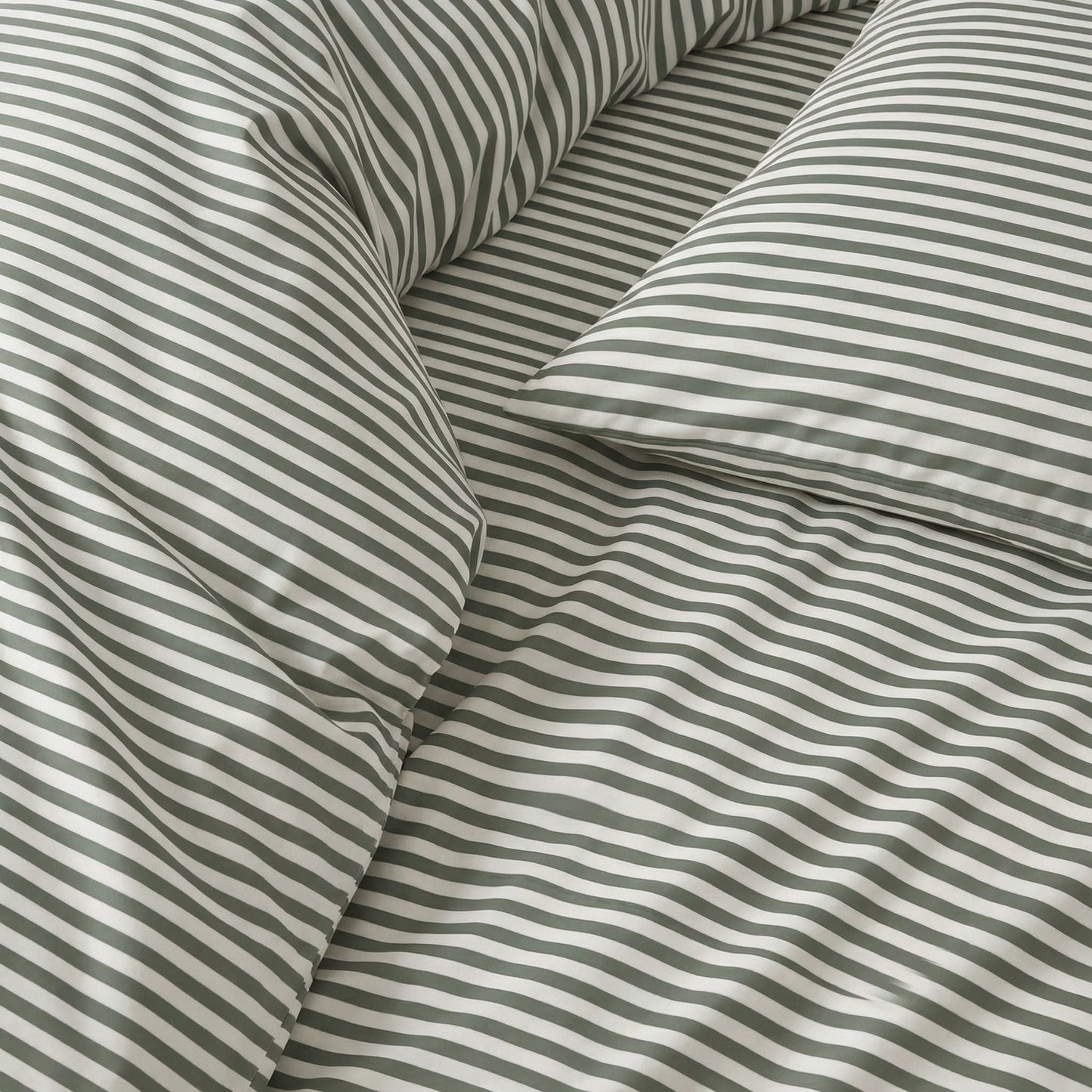 Close-up of thin gray-and-white striped bedding fabric with smooth sateen sheen