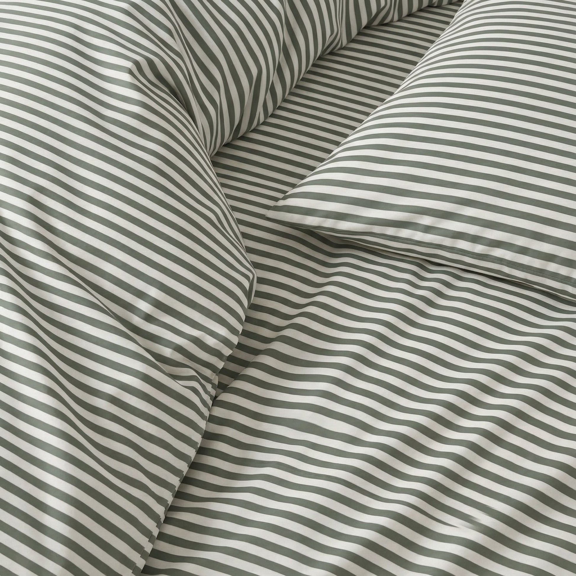 Close-up of thin gray-and-white striped bedding fabric with smooth sateen sheen