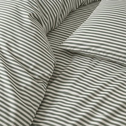 Close-up of thin gray-and-white striped bedding fabric with smooth sateen sheen