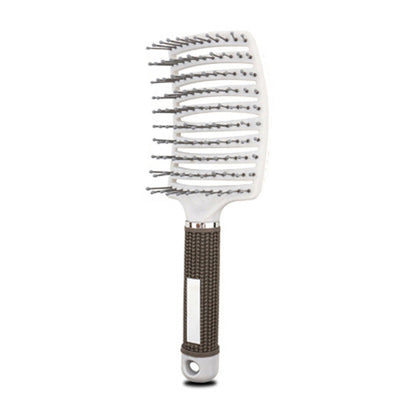 White massage hair comb with pin tips and dark gray textured handle
