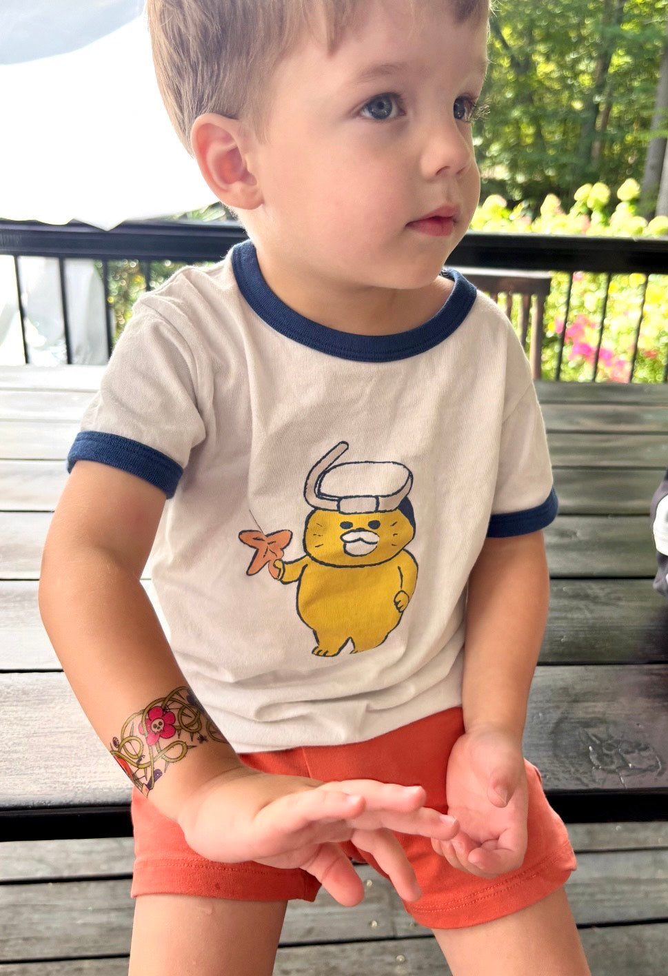 Temporary kids tattoo band on child's forearm, Halloween cartoon skull and bat