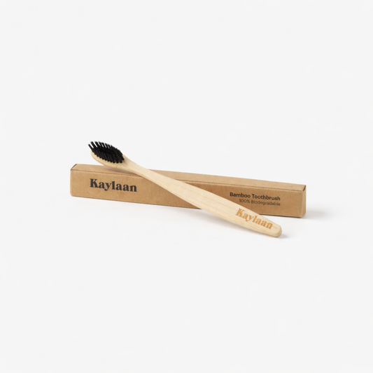 Kaylaan bamboo toothbrush with black bristles, in cardboard sleeve