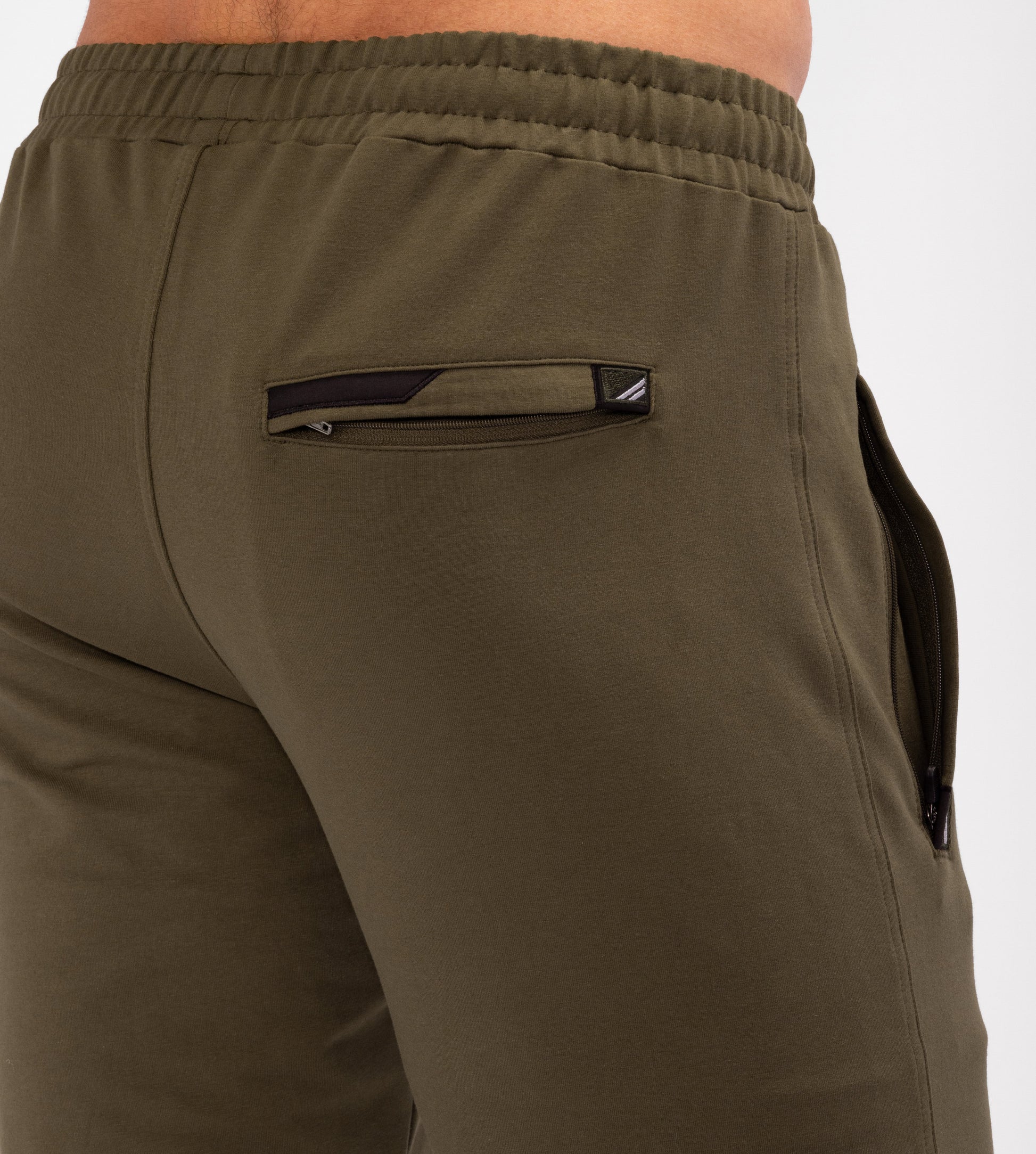 Olive tapered athletic sweatpants with elastic waistband and side pocket with zip pull