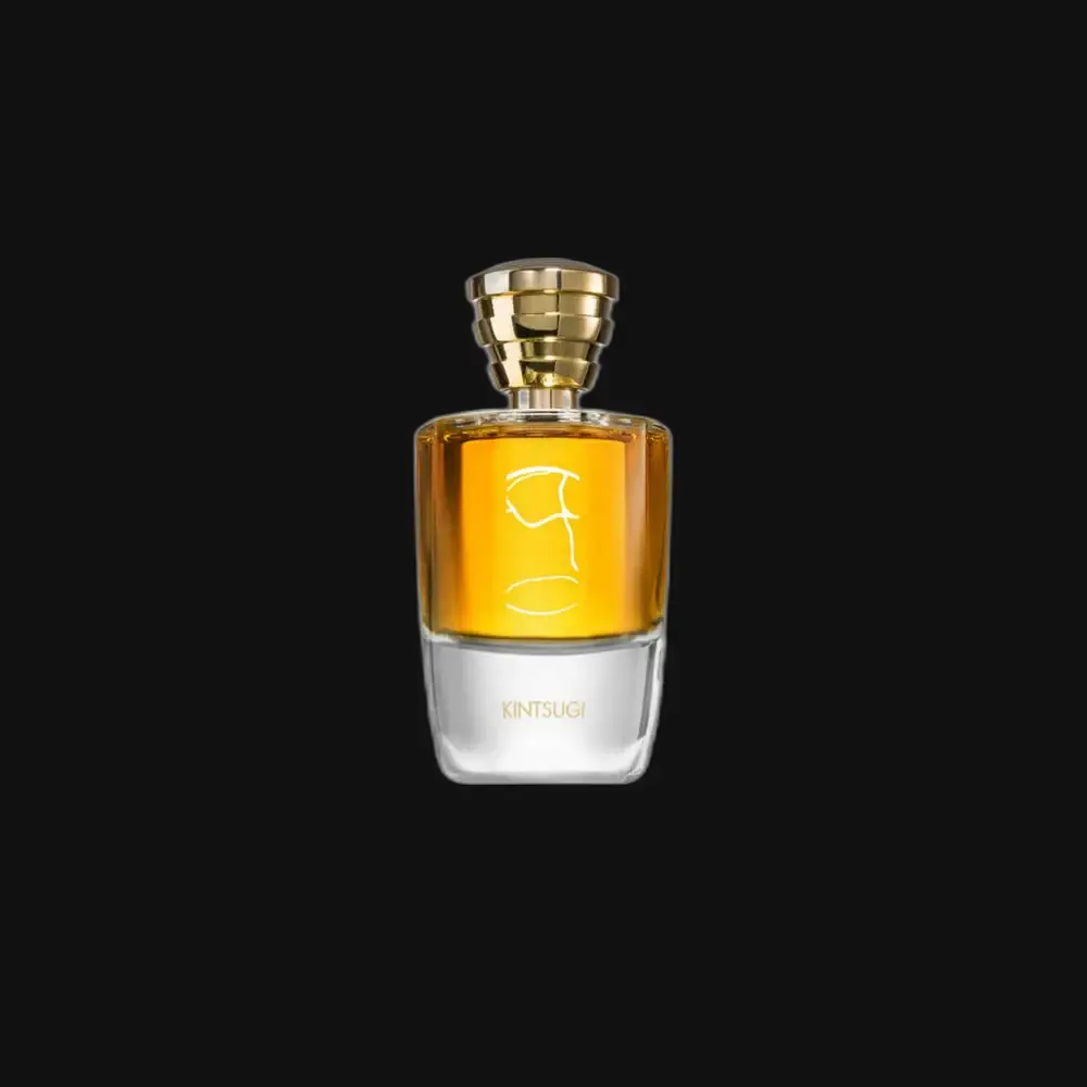 Unisex fragrance bottle with gold cap and amber liquid, clear glass base and label