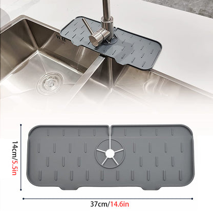 Grey kitchen faucet mat with central drain wheel and raised drip ridges