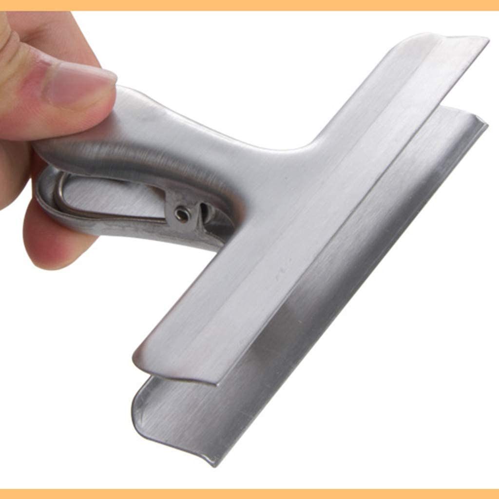 Stainless steel chip clip held by hand, clamp latch visible for bag sealing