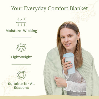 Waffle weave blanket, pale green waffle texture worn by a person holding a mug