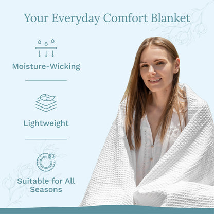 Waffle weave blanket draped over a person, white waffle-textured fabric