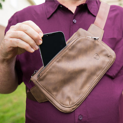 Vegan leather crossbody fanny pack with front zipper and shield logo on flap