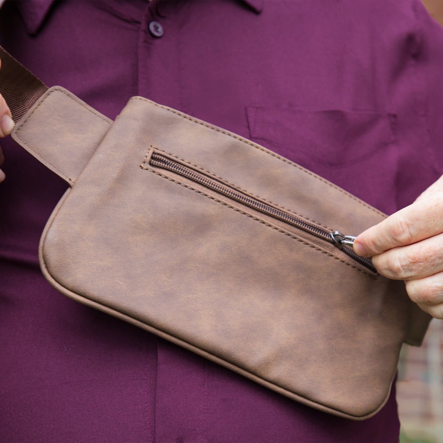 Vegan leather crossbody fanny pack close-up of front zipper pocket