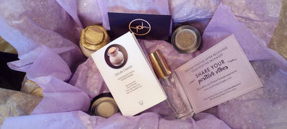 Skincare gift set flat lay with jars, tubes, and printed instruction cards