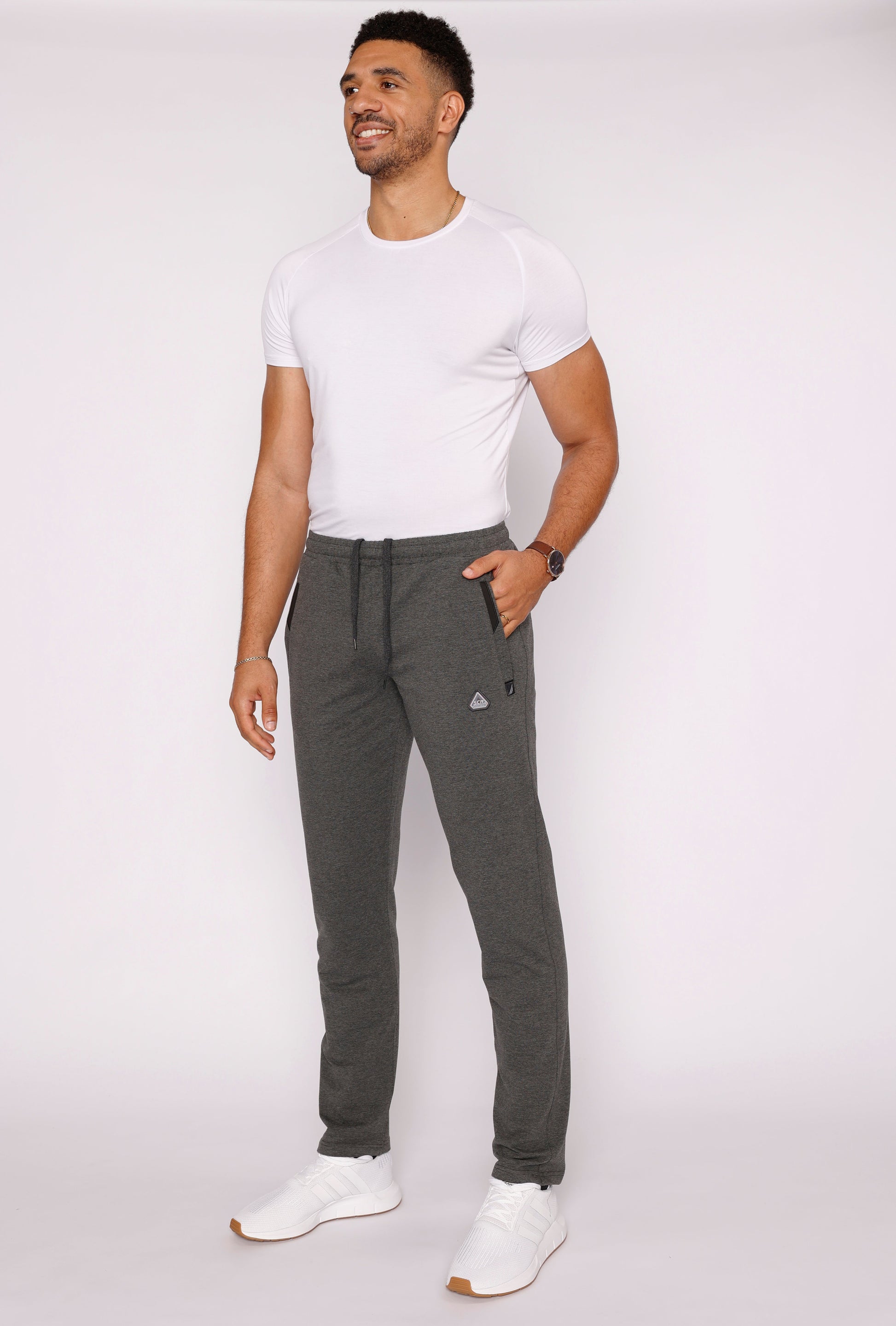 Dark gray athletic sweatpants with tapered fit and elastic drawstring waistband