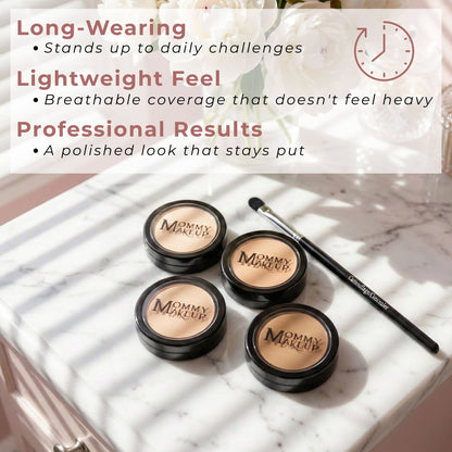 Set of concealer compacts with black lids in tan tones, plus makeup brush
