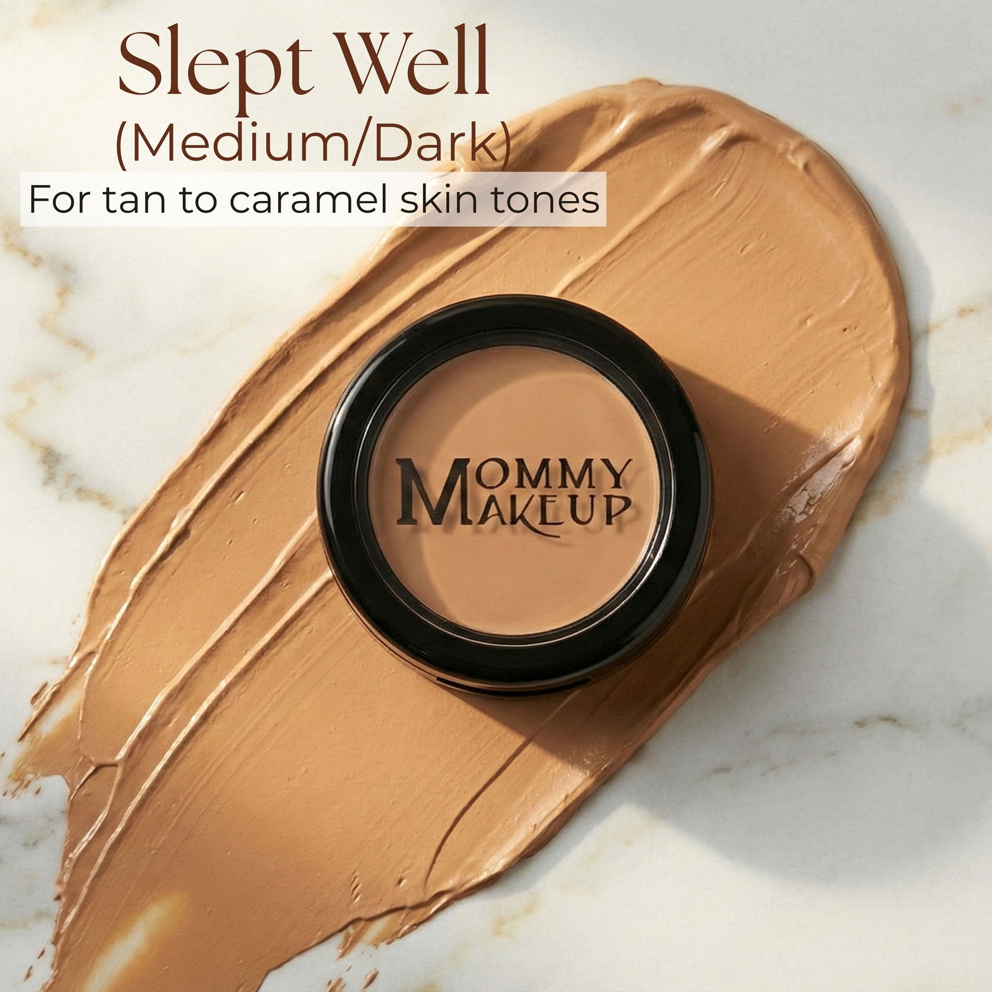 Concealer compact with black lid and tan medium-dark cream swatch