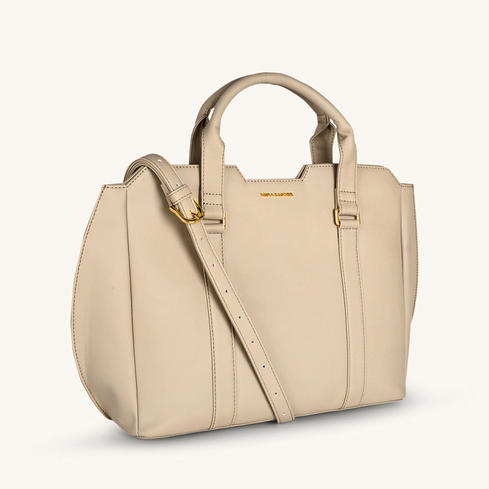 Light taupe crossbody bag with curved top handles and front seam detailing
