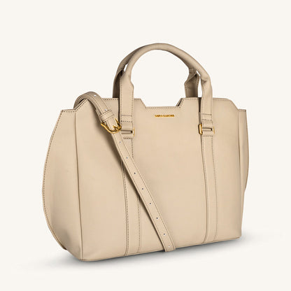 Light taupe crossbody bag with curved top handles and front seam detailing