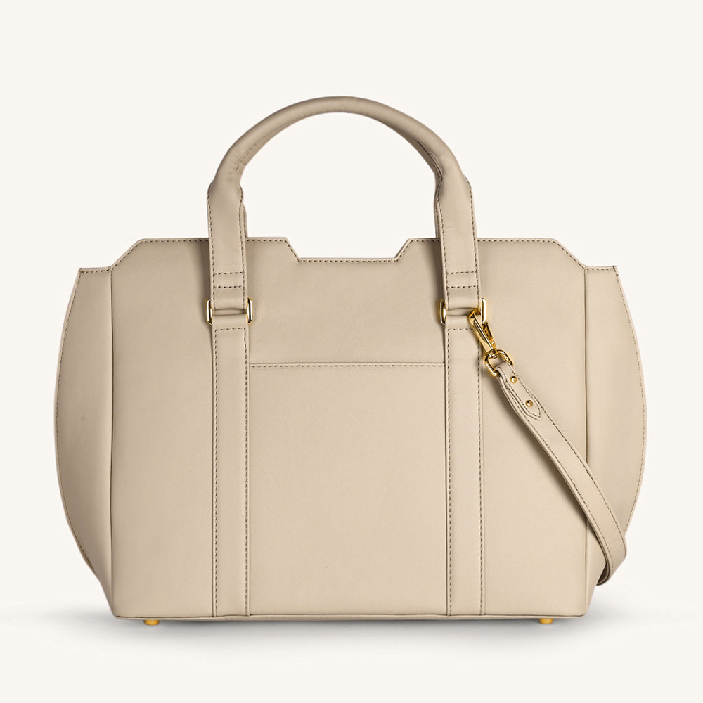 Light taupe crossbody bag with front zip pocket, top handles, and gold hardware