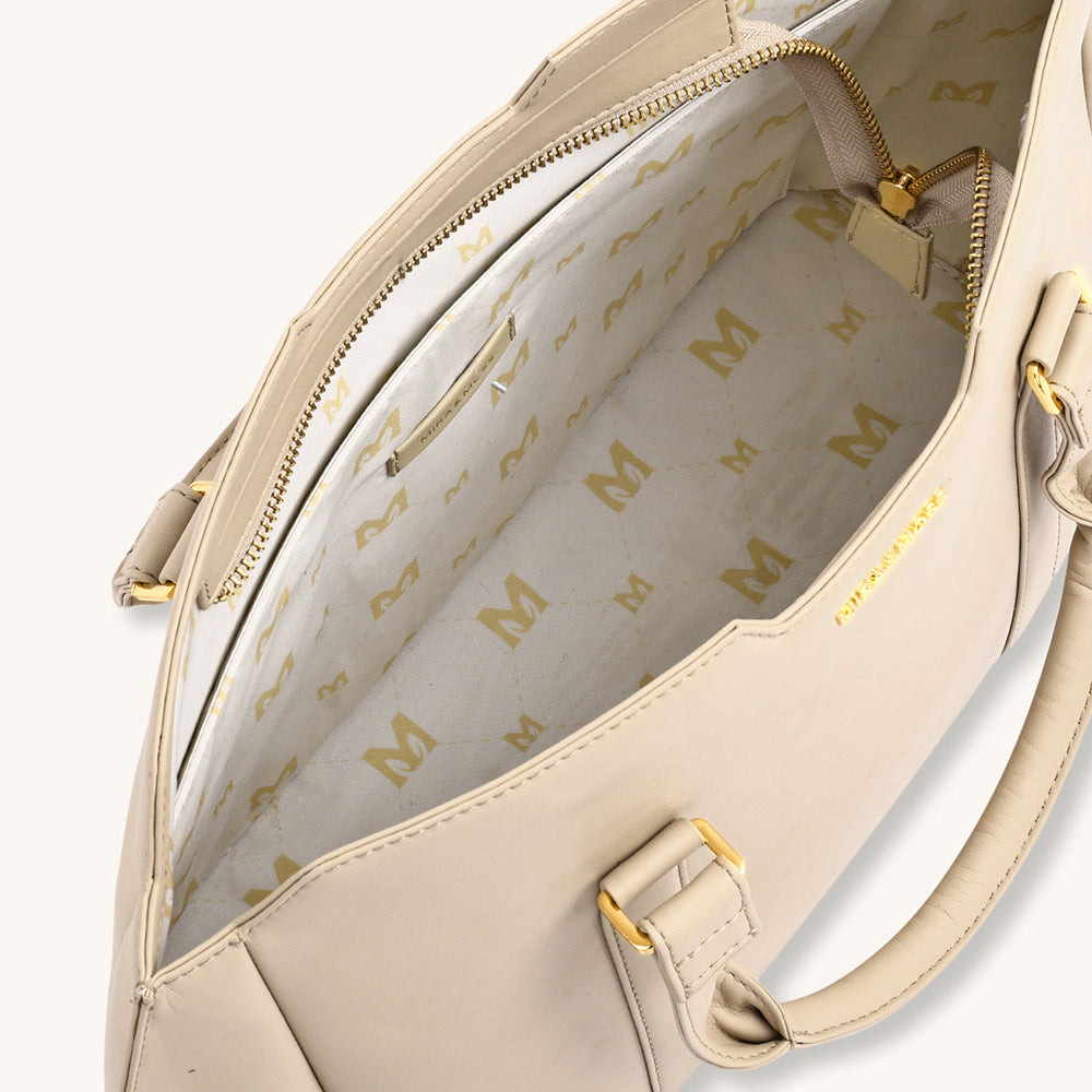 Light taupe crossbody bag interior view with lined pocket and gold zipper pulls