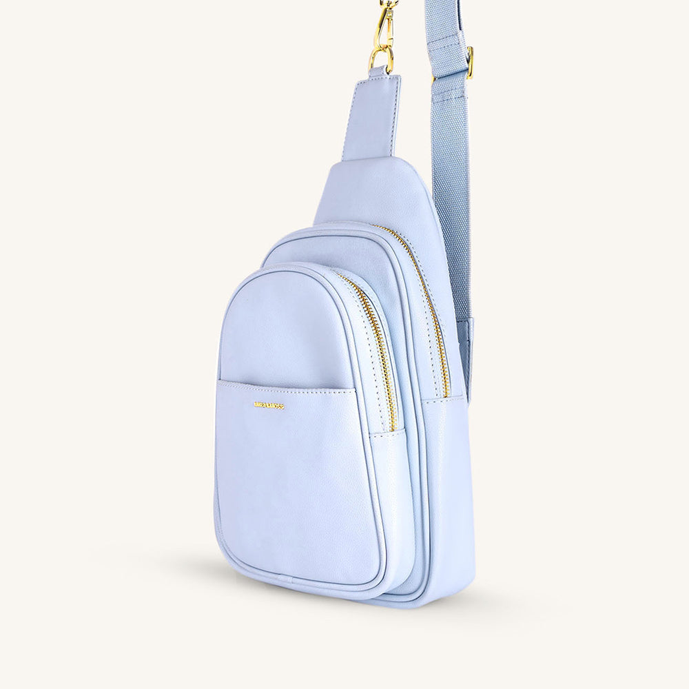Ice blue fanny bag angled view with double zip compartments