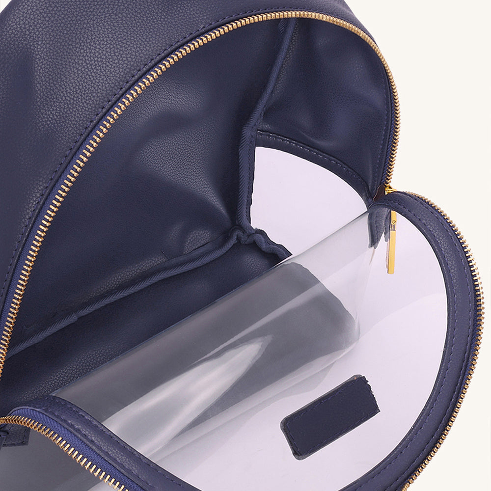 Navy clear backpack interior pocket with gold zipper trim and small label