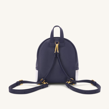 Navy backpack with gold zipper pull, front clear panels, and twin shoulder straps