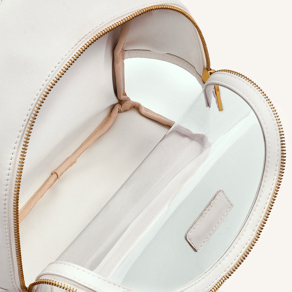 Ivory clear-front mini backpack interior with beige lining and zippered opening