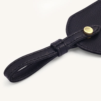 Black leather travel tag with stitched strap and round gold snap button
