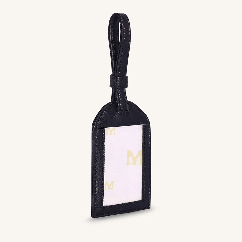 Black leather travel tag with clear label window and gold logo accents