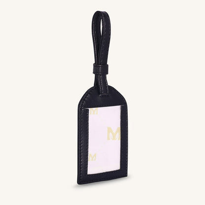 Black leather travel tag with clear label window and gold logo accents
