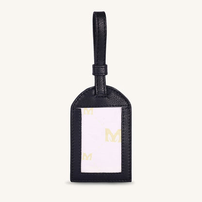 Black leather travel tag with gold M logo and looped top strap