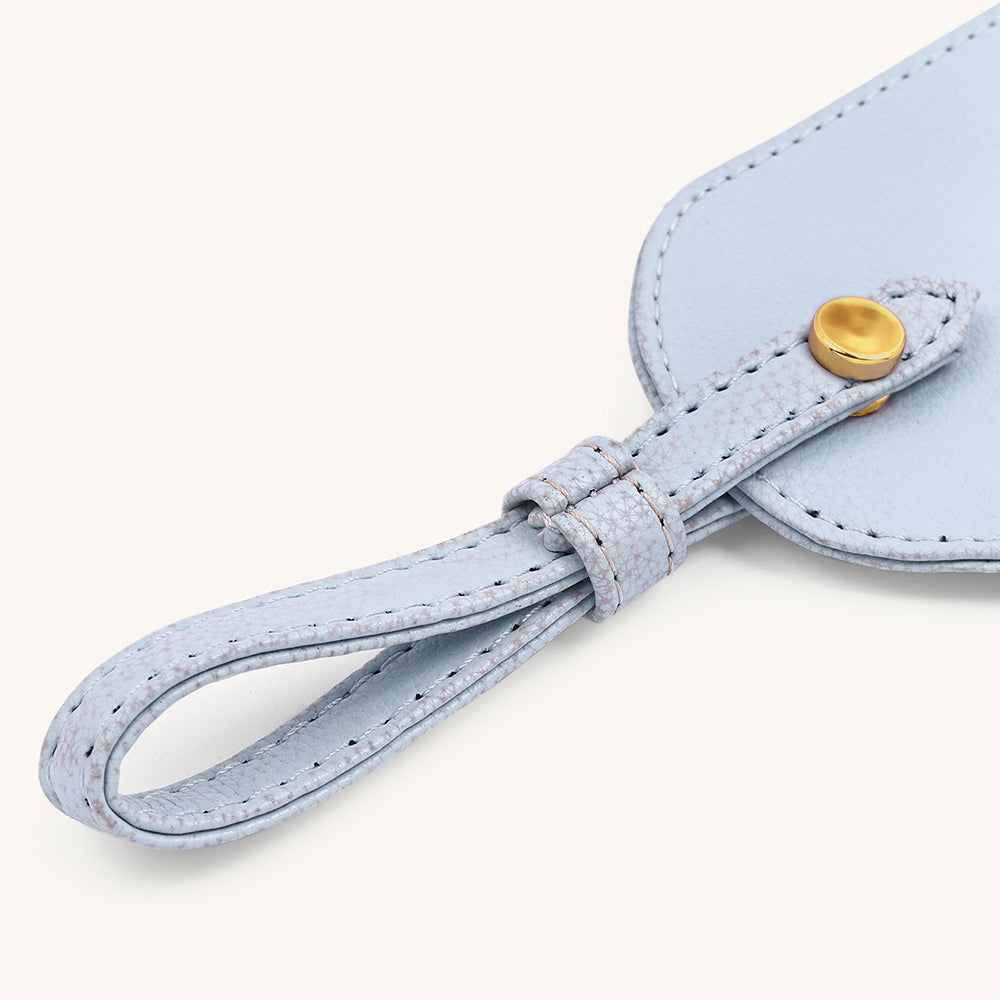 Ice blue leather travel tag strap with gold snap button and stitched edging