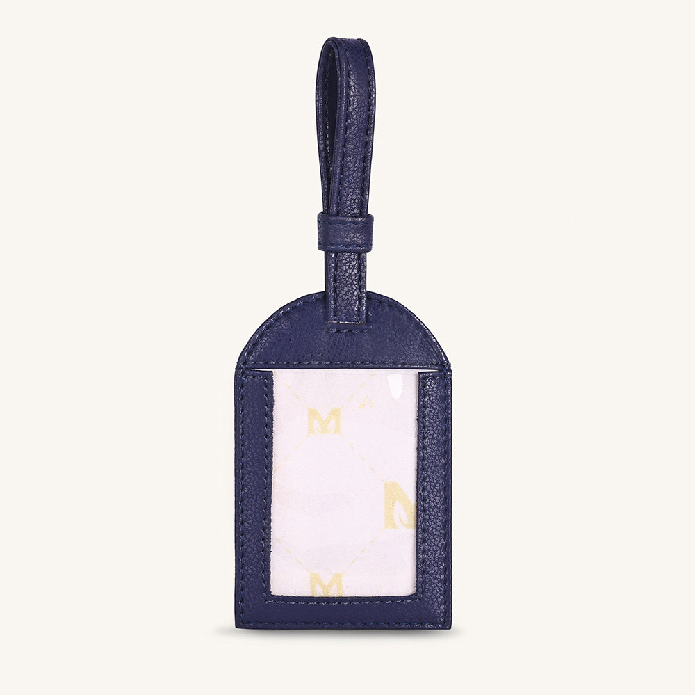 Alexis travel tag with dark blue leather and clear ID window, gold accents