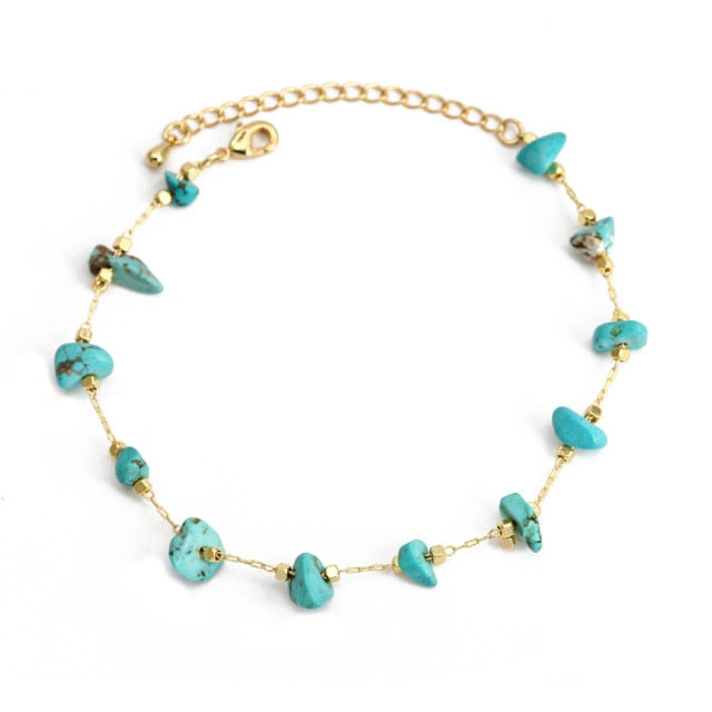 Gold charm bracelet with turquoise cross and bead charms, small links and clasp