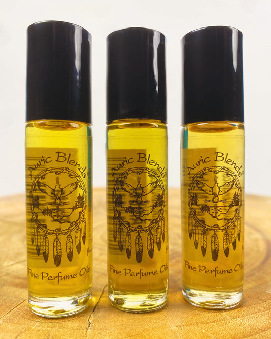 Set of three roll-on perfume bottles with black caps and gold amber oil, Auric Blends labels