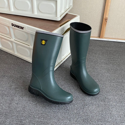 Dark green knee-high rain boots with gray-trim cuff and textured rubber tread sole.