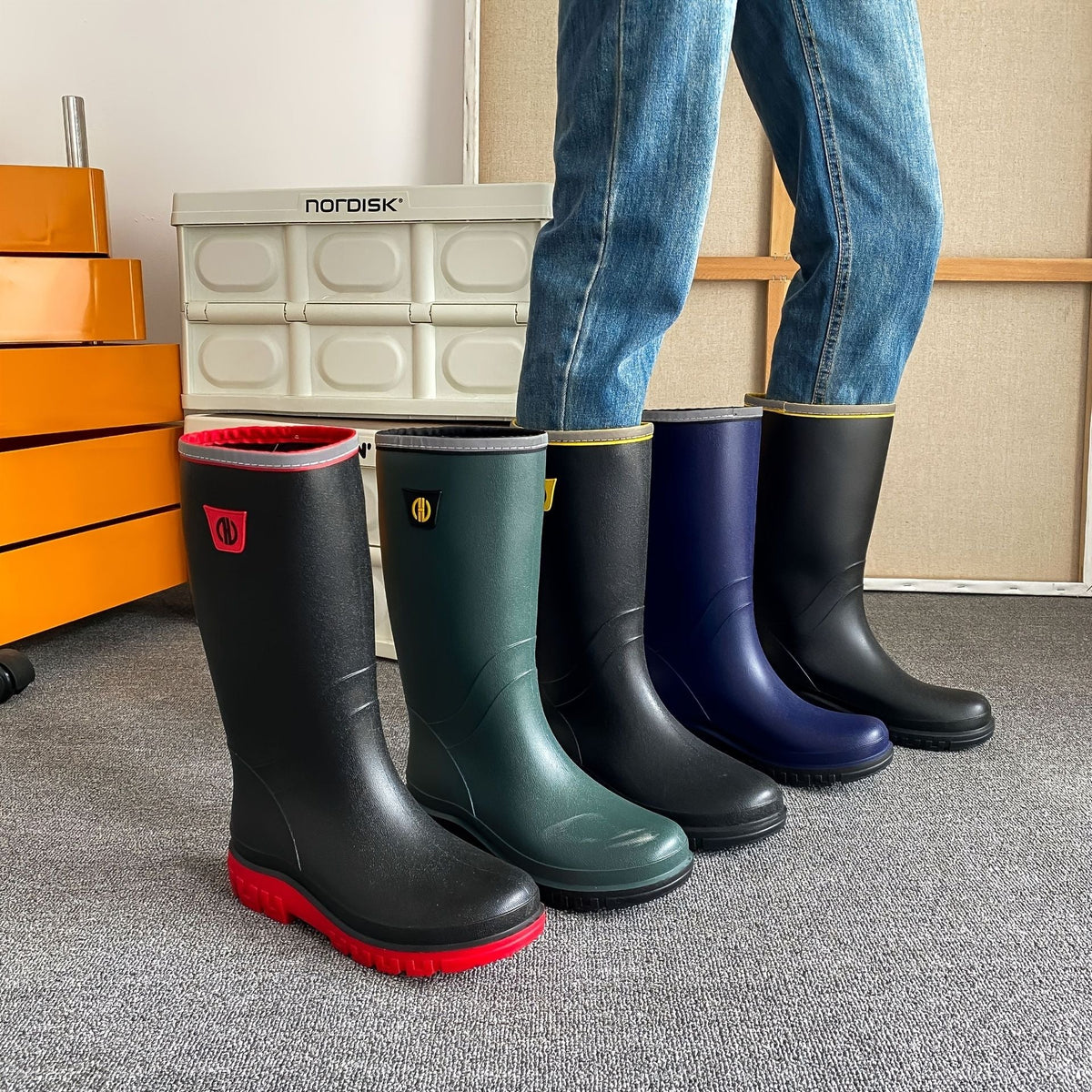 Knee-high rain boots in black, dark green, and navy with treaded outsoles.