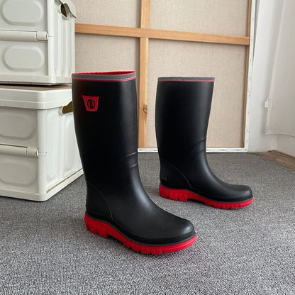 Knee-high rain boots in black rubber with red outsole and red edge trim