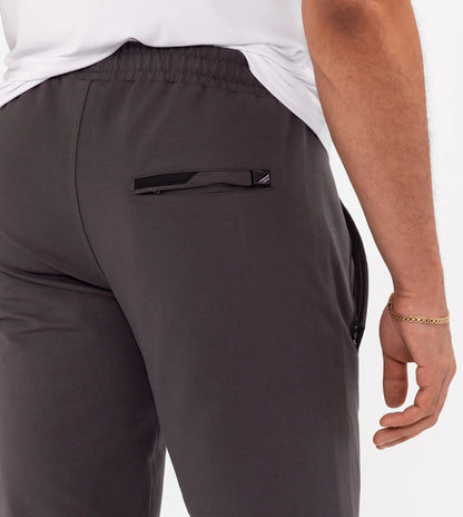 Athletic sweatpants with elastic waistband and side pockets; dark grey.