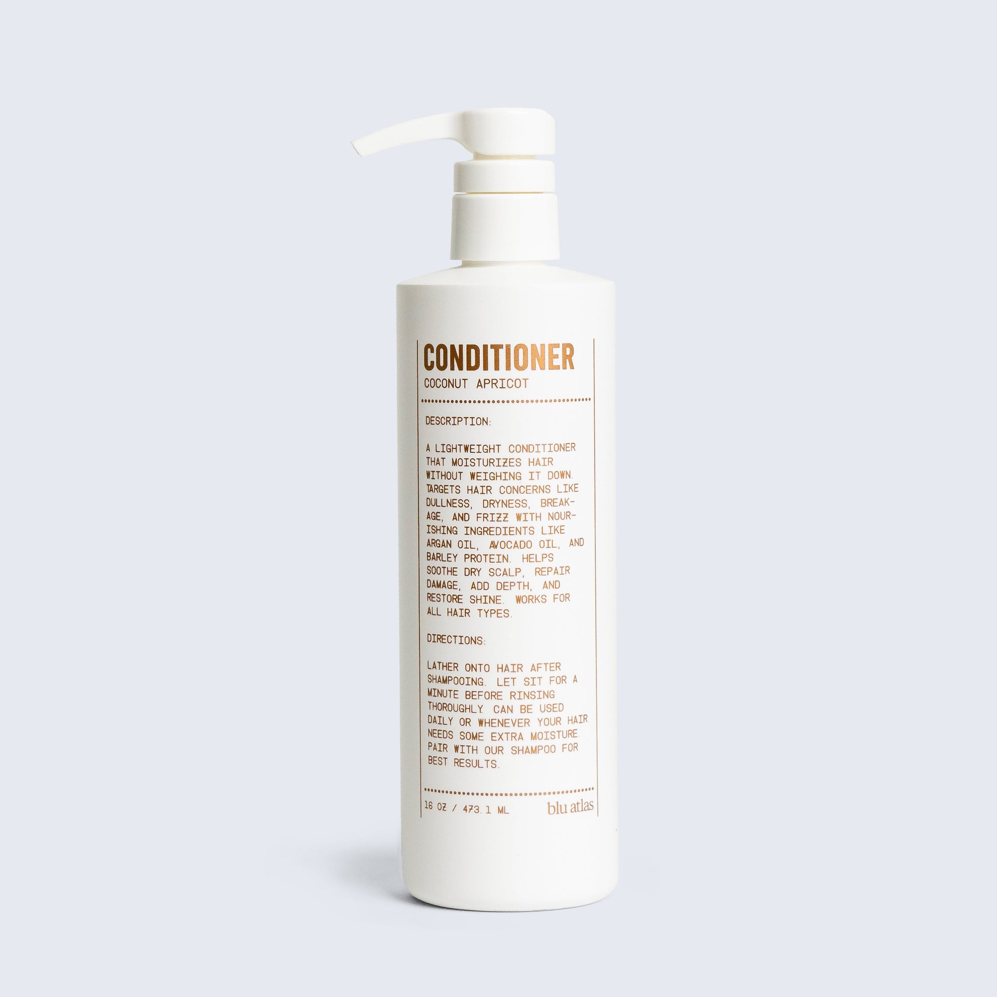 Conditioner bottle with pump, coconut apricot scent label visible