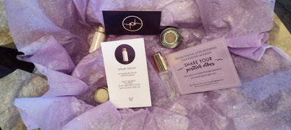 Skincare gift box contents with bottles, jars, and printed cards on tissue paper