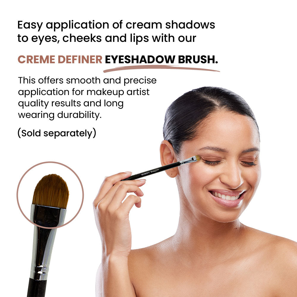 Cream-to-powder applied with a brush to a woman’s eyelid in peach-gold tones