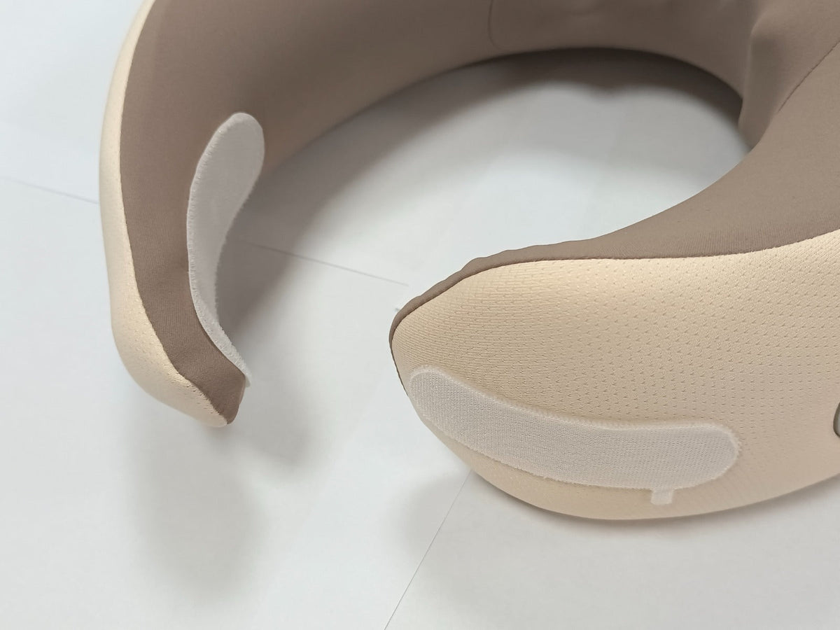 Beige U-shaped neck massage pillow with inner support and raised side pads