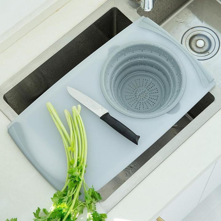 Light blue plastic chopping board with round perforated draining insert