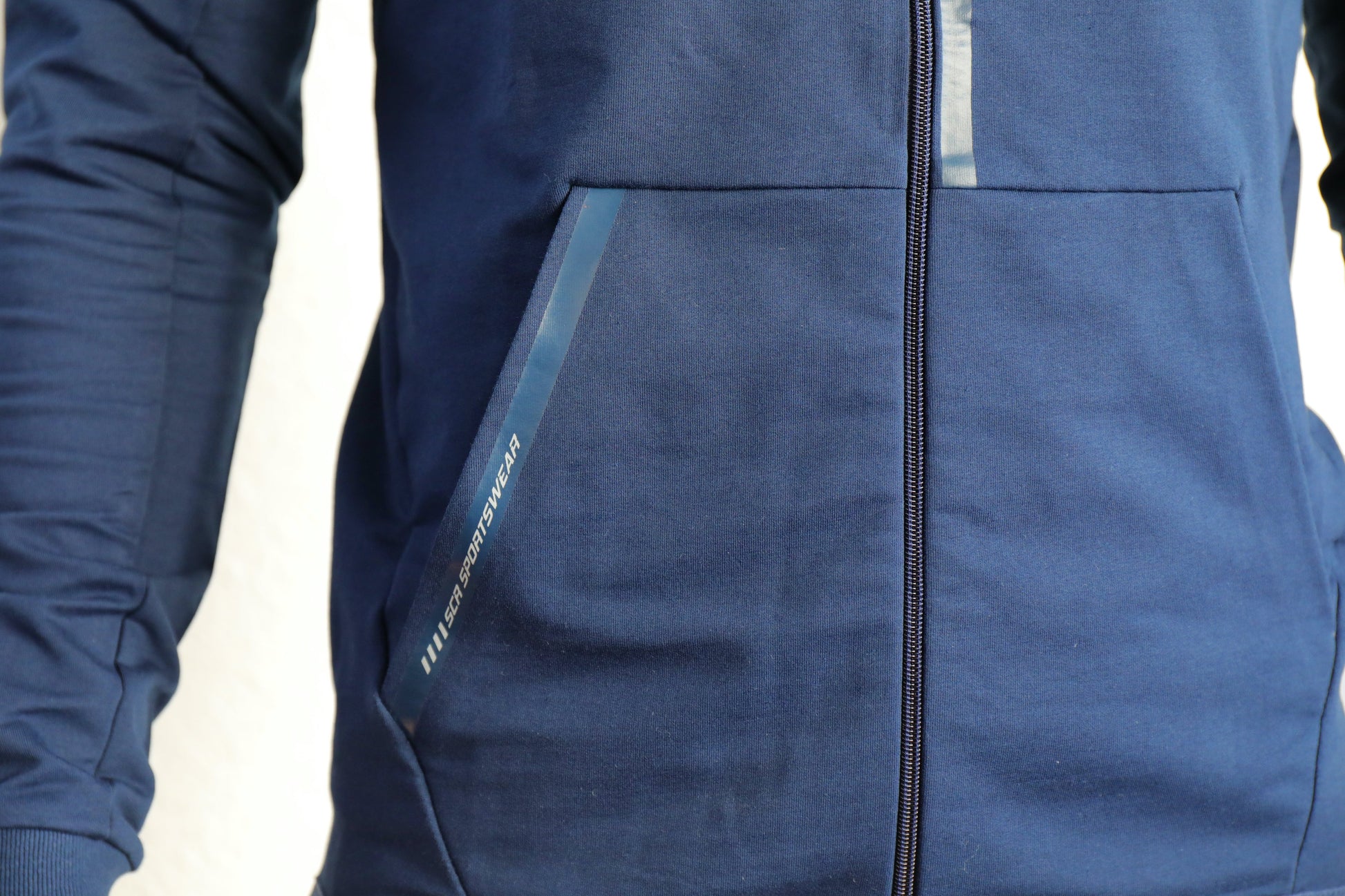 Navy zip-up hooded slim-fit sweatshirt with front pockets and zipper seam detail