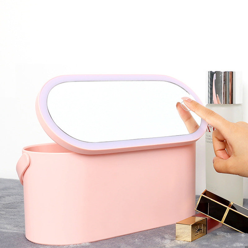Pink makeup organizer box with hinged lid handle and open top for storing cosmetics
