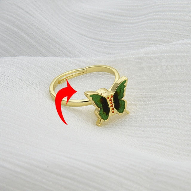 Butterfly rotatable ring with gold band and blue butterfly enamel, spinning arrow