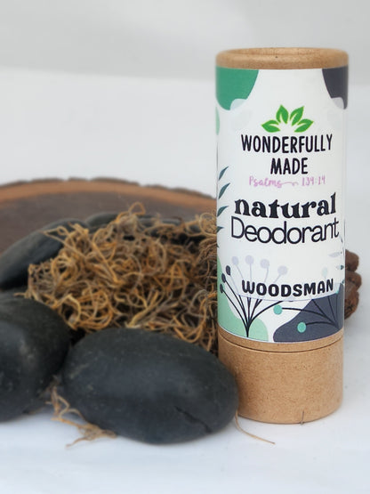 Natural deodorant stick in cardboard tube, Woodsman scent, purple label text.